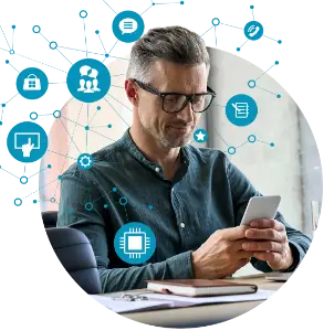 A man is sitting at a desk and business texting from a cell phone